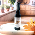 Black plastic spray bottle with a white label.