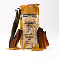 Glass salt jar with wooden lid. Vanilla bean, bacon, and syrup drip of lid.