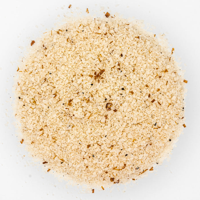 Mound of off white salt with brown flecks.