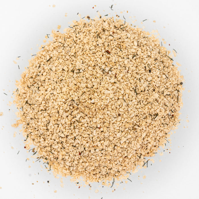 Mound of beige salt with flecks of herbs.
