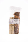 Henry Bell wooden insect oil log feeder hanging on a jute cord with four suet logs in its drilled holes