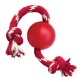 KONG ball in natural red rubber with a knotted rope threaded through it, held out by the rope