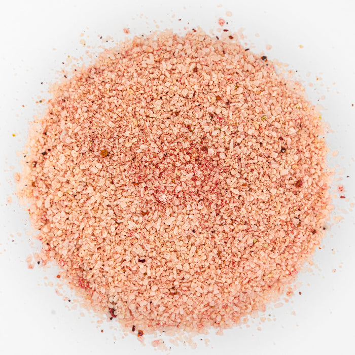 Mound of salt. Pink in color with bits of dark red.