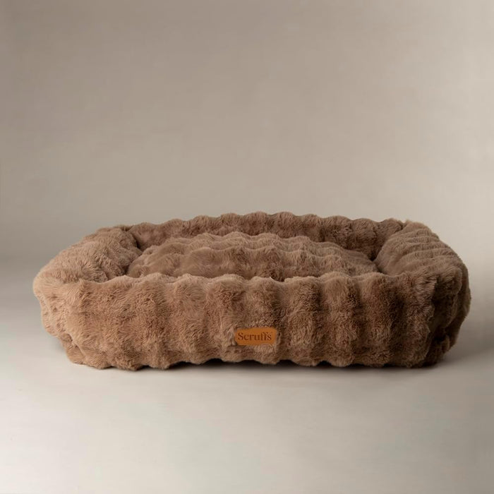 Scruffs Alpine taupe box bed photographed at an angle, showing the height of the bolster wall